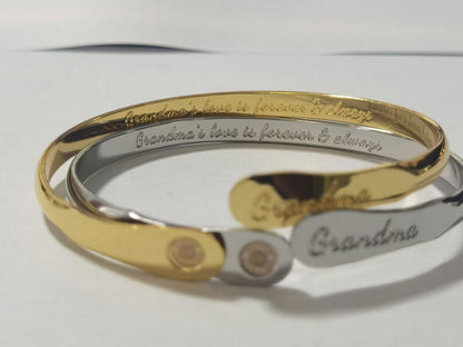 Gold-toned cuff bracelet with “Grandma” engraving and round charm inset