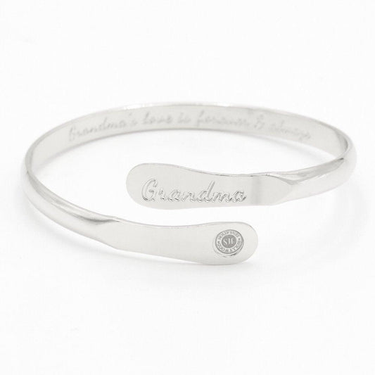 Silver-toned cuff bracelet with engraved “Grandma” and round charm detail