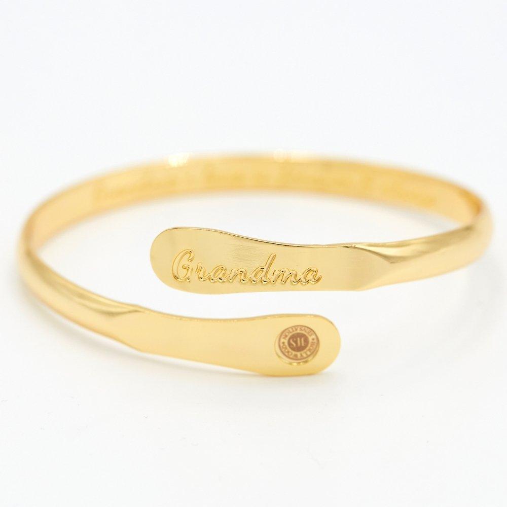 Gold-tone cuff bracelet with 'Grandma' engraving and small round logo charm