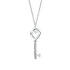 Heart-shaped charm and key pendant necklace on a silver-tone chain