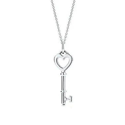 Heart-shaped charm and key pendant necklace on a silver-tone chain