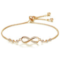 Gold infinity bracelet with adjustable chain and small crystal accents