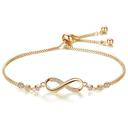 Gold infinity bracelet with adjustable chain and small crystal accents