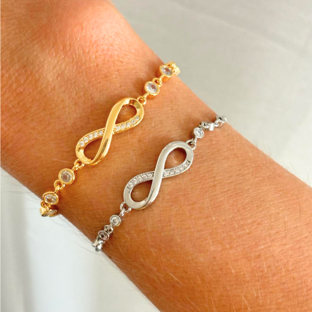 Infinity bracelets in gold and silver with crystal accents on wrist