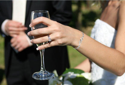 Silver infinity-link bracelet on wrist, slim chain with open loop motif