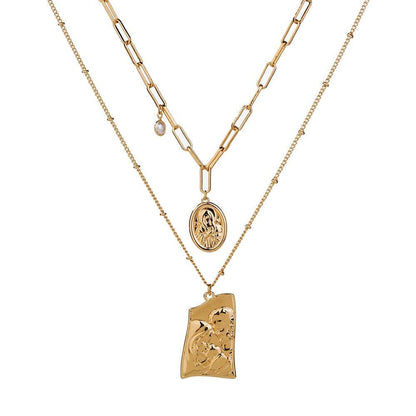 Gold layered necklace with Jesus pendant and round medallion, linked chain.