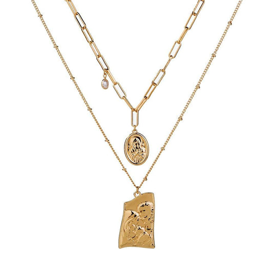 Gold layered necklace with Jesus pendant and round medallion, linked chain.