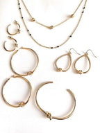 Gold hoop earrings set with twisted knot accents on round hoops
