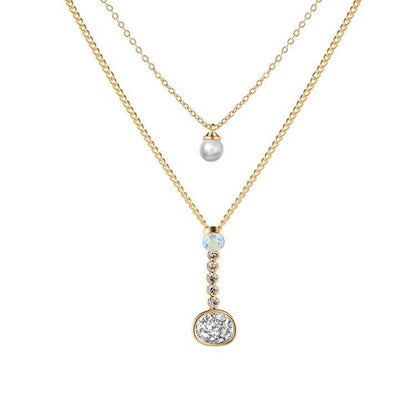 Layered gold-tone necklace with pearl, crystal, and round druzy-style pendant