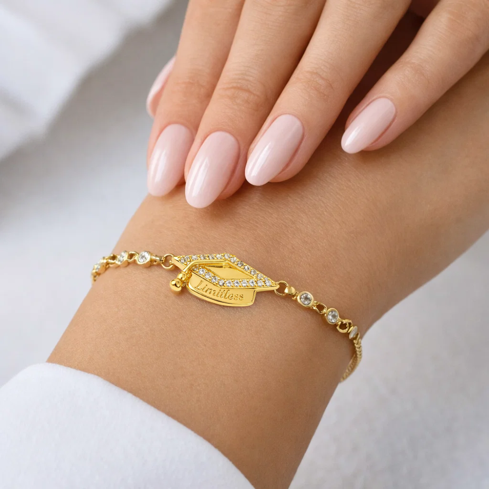 Gold adjustable bracelet with pavé graduation cap charm and stone accents