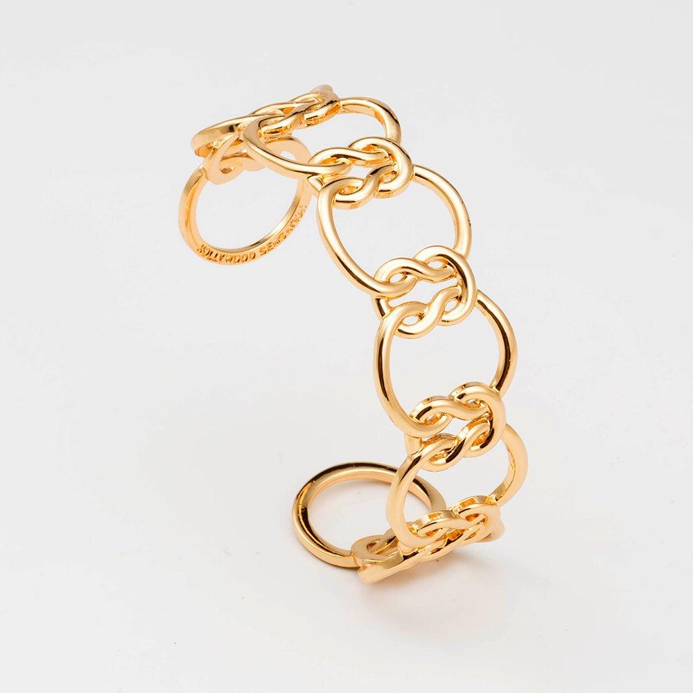 Gold love-knot link bracelet with chunky chain links and interlocking oval loops