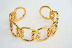 Gold love-knot link bracelet with oval links and small knot charm accents