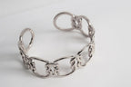 Silver chain love-knot bracelet with interlocking ring links and clasp detail