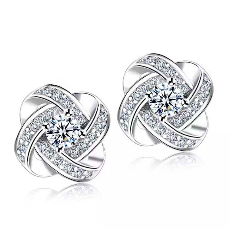 Silver love knot stud earrings with crystal center, shown as a pair