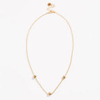 Gold-tone oval necklace with love-knot charms at the ends