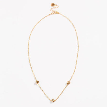 Gold-tone oval necklace with love-knot charms at the ends