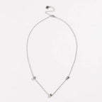 Silver-tone oval necklace with love-knot charms at the ends