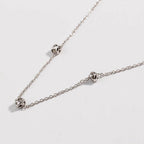 Silver-tone chain necklace with love-knot clasp and small knot links