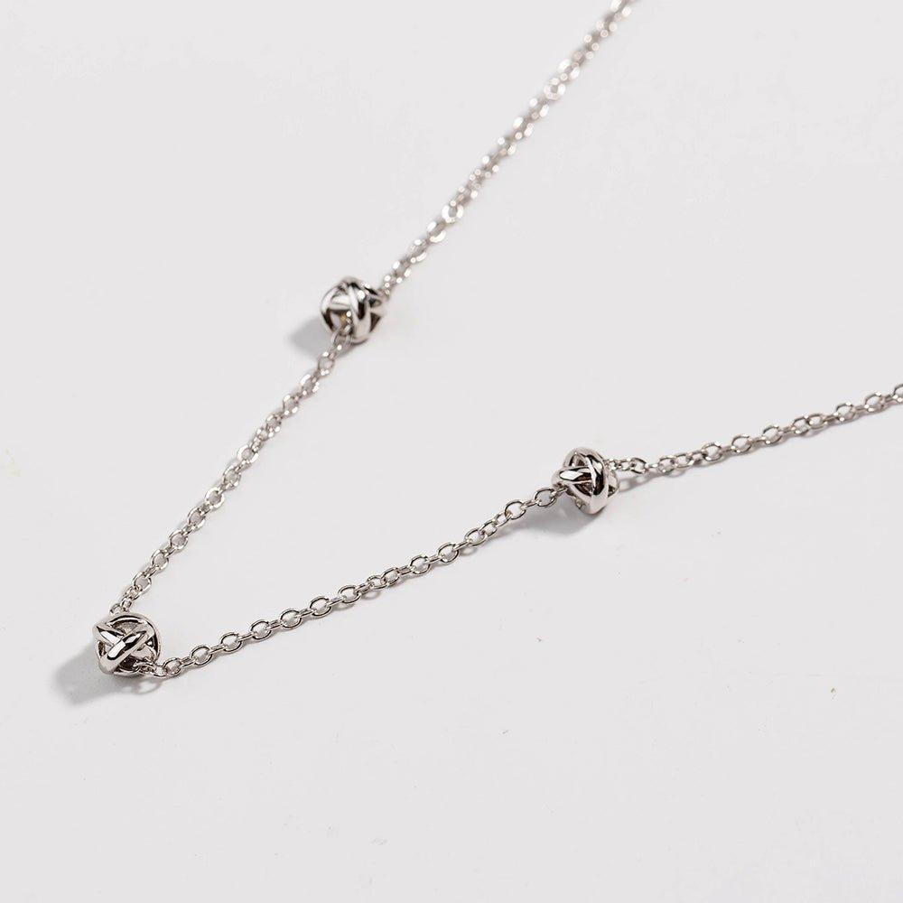 Silver-tone chain necklace with love-knot clasp and small knot links