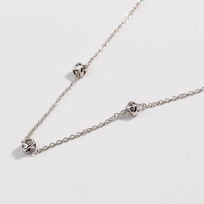 Silver-tone chain necklace with love-knot clasp and small knot links