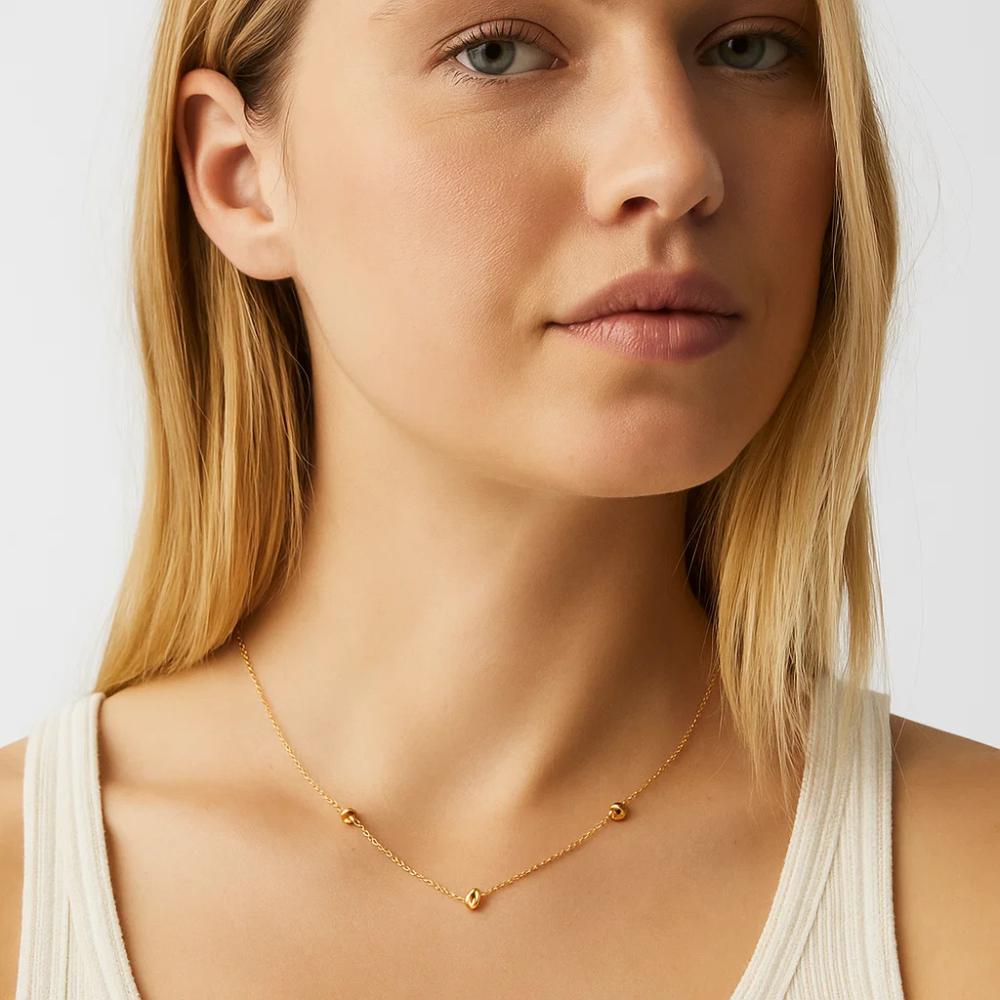 Gold-tone delicate chain necklace with love-knot charm