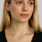 Silver-tone chain necklace with small love-knot charm at center
