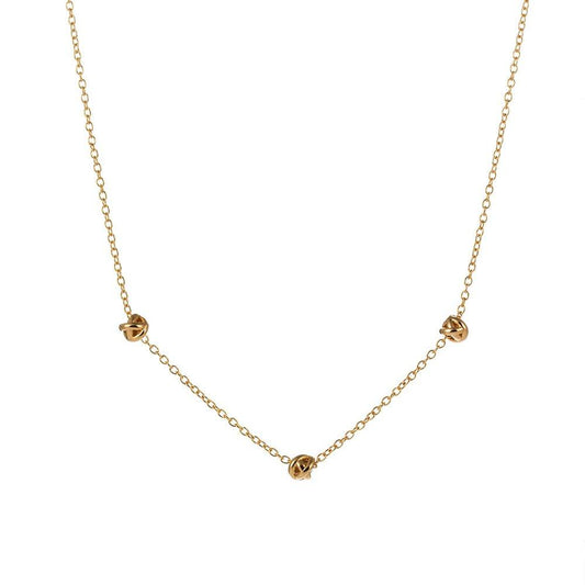 Gold-tone chain necklace with small love-knot pendant at the center