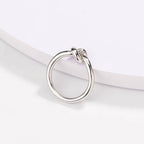 Silver love knot commitment ring with sculpted knot top, polished finish