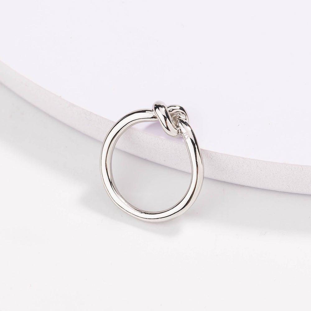 Silver love knot commitment ring with sculpted knot top, polished finish