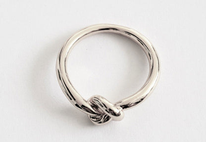 Silver love-knot commitment ring with twisted knot detail, polished band