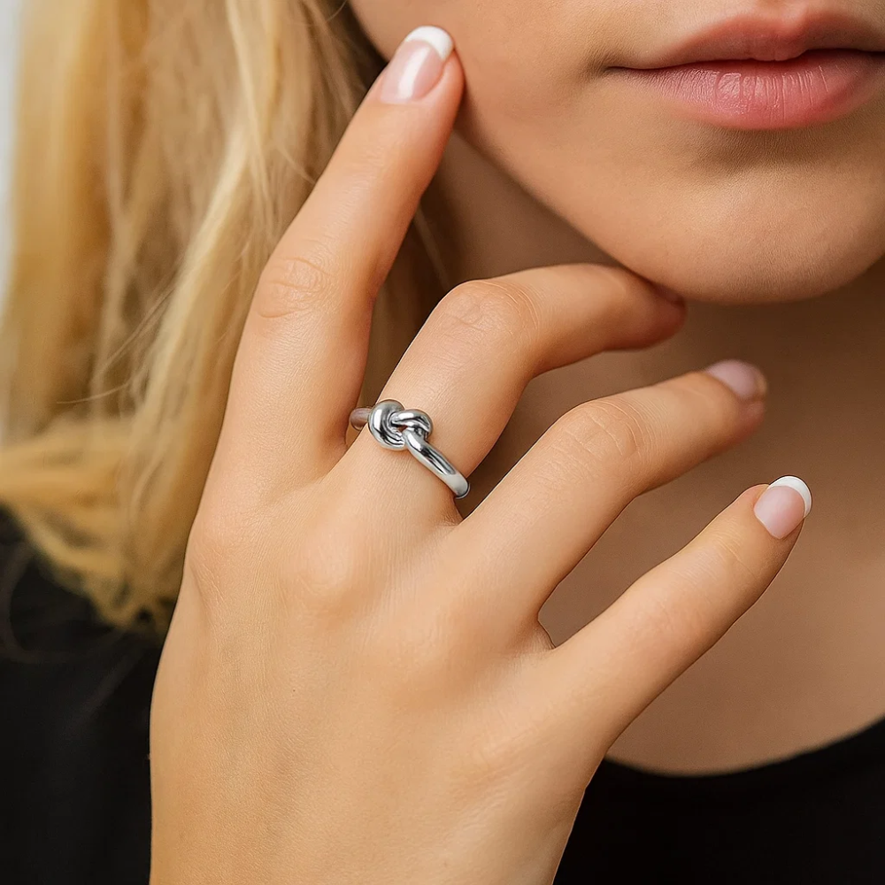 Silver love-knot ring with twisted knot detail and polished band