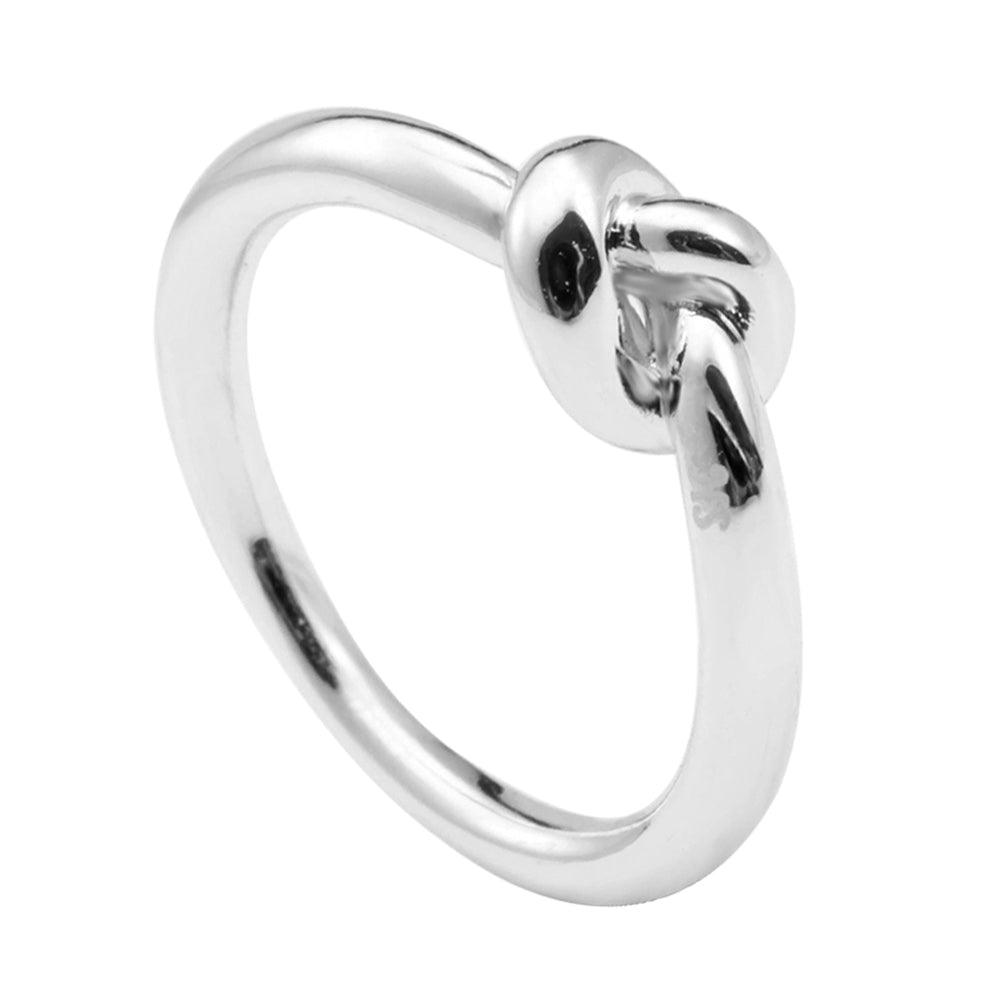 Silver love knot commitment ring with dark center stone, polished band