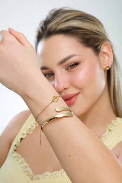 Gold-tone paw print bracelet worn on wrist