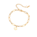 Gold link bracelet with delicate paw-print charm and lobster clasp