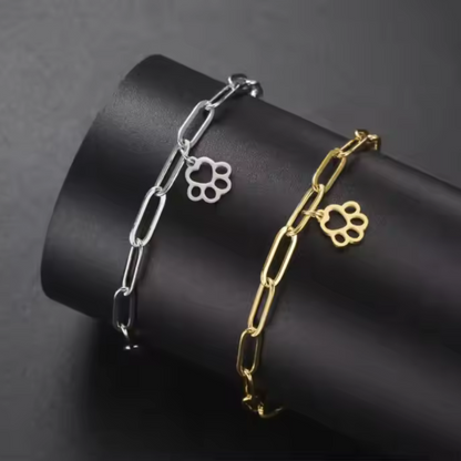 Set of gold and silver link bracelets with small paw-print charms