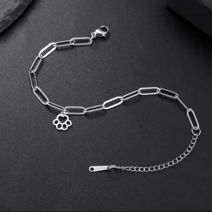 Silver link bracelet with paw-print charm, chain links, and clasp detail