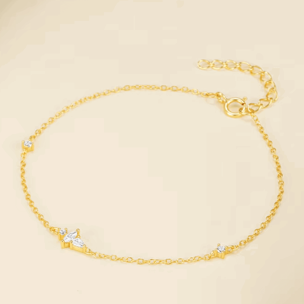 Gold cable chain bracelet with marquise CZ accents along the link line