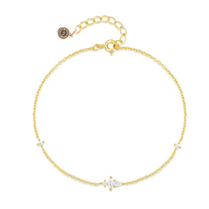 Gold delicate chain bracelet with tiny CZ stones and round logo charm