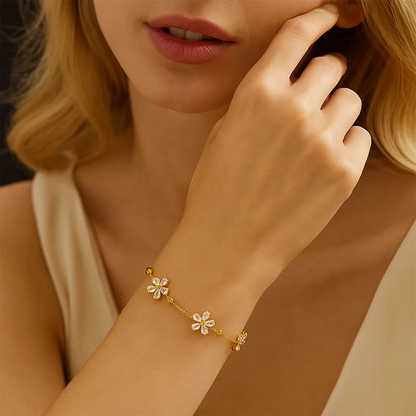 Gold-tone bracelet with crystal flower accents and adjustable clasp