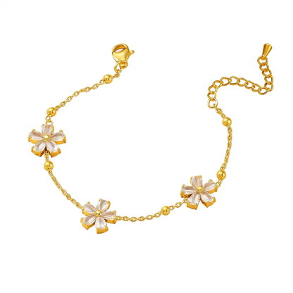 Gold-tone crystal blossom bracelet with five flower charms and heart-shaped links