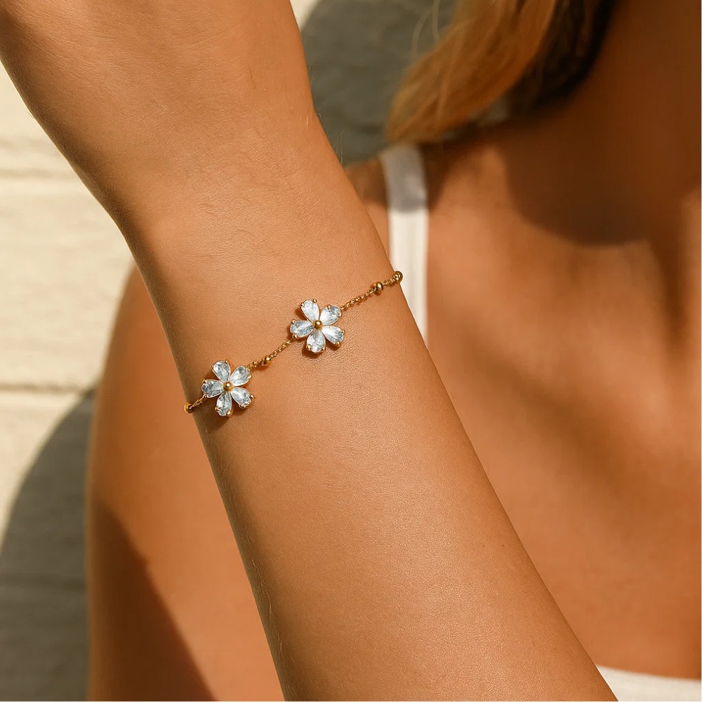 Gold-tone crystal blossom bracelet with two flower charms on the wrist
