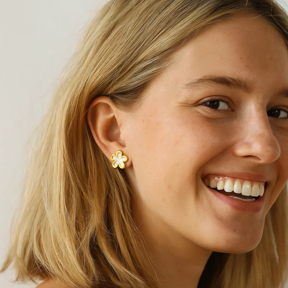 Gold-tone crystal blossom stud earrings with floral cutout design
