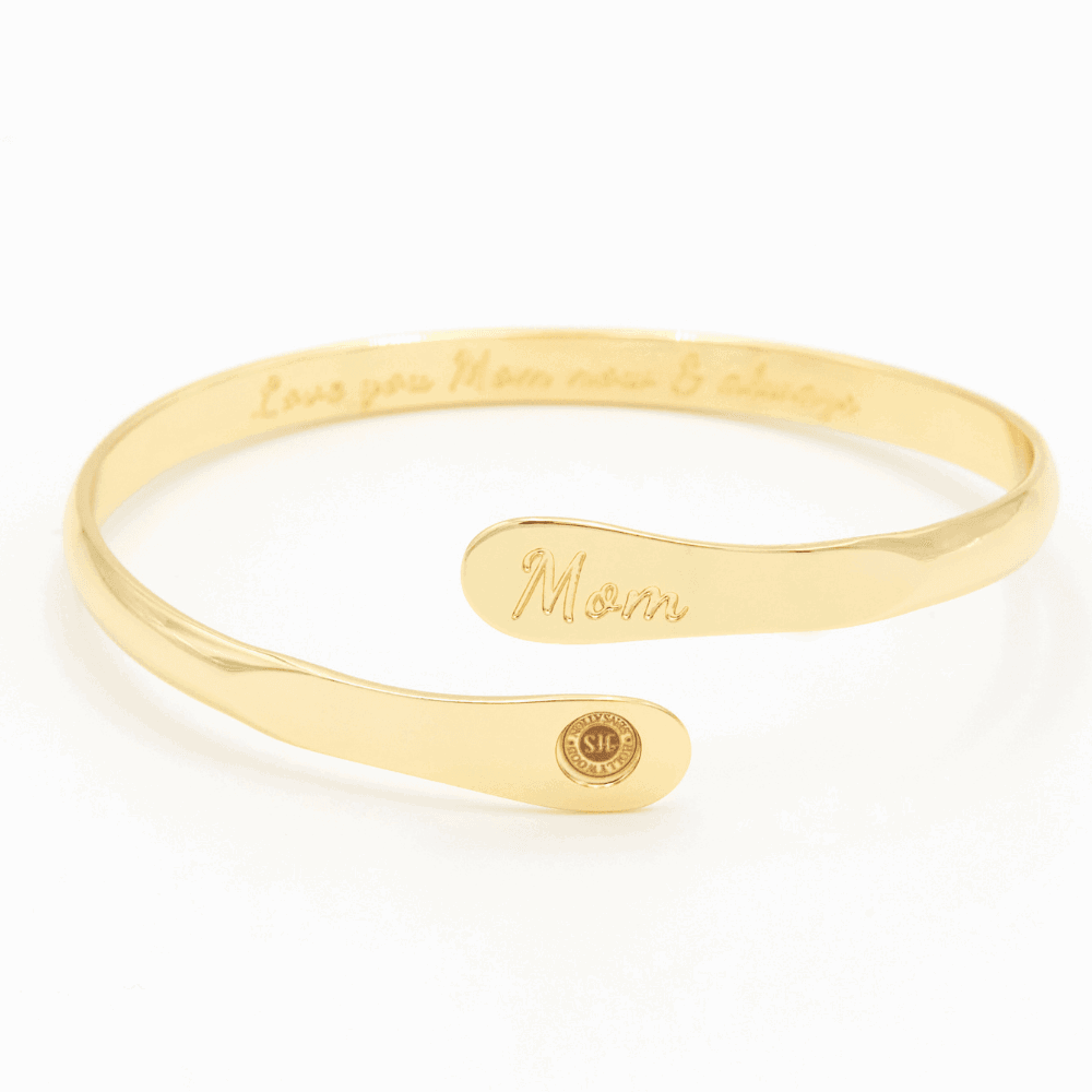 Gold-tone engraved mom cuff bracelet with script “Mom” and round emblem