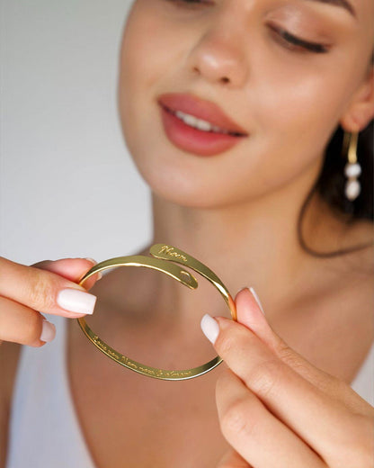 Gold-tone mom cuff bracelet, close-up of engraved script and wide bangle