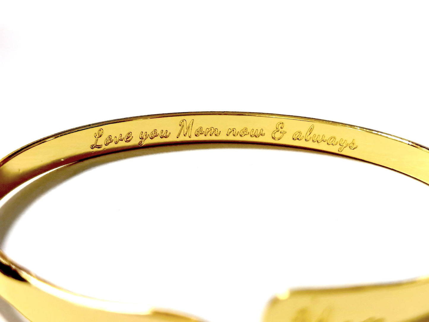 Gold mom bangle bracelet with engraved inner sentiment along the inner curve