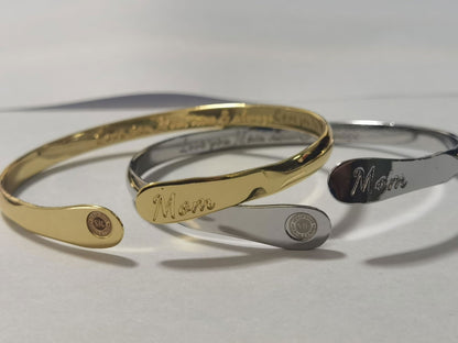 Set of gold and silver mom bangle bracelets with oval “Mom” engravings and round emblems