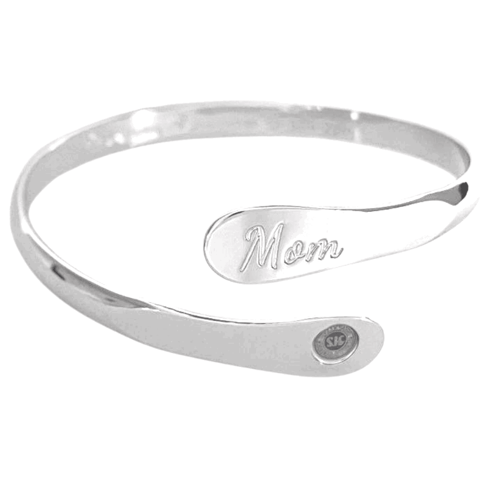 Silver mom bangle bracelet with oval “Mom” engraving and small round emblem near the end