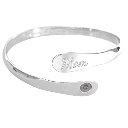 Silver mom bangle bracelet with oval “Mom” engraving and small round emblem near the end