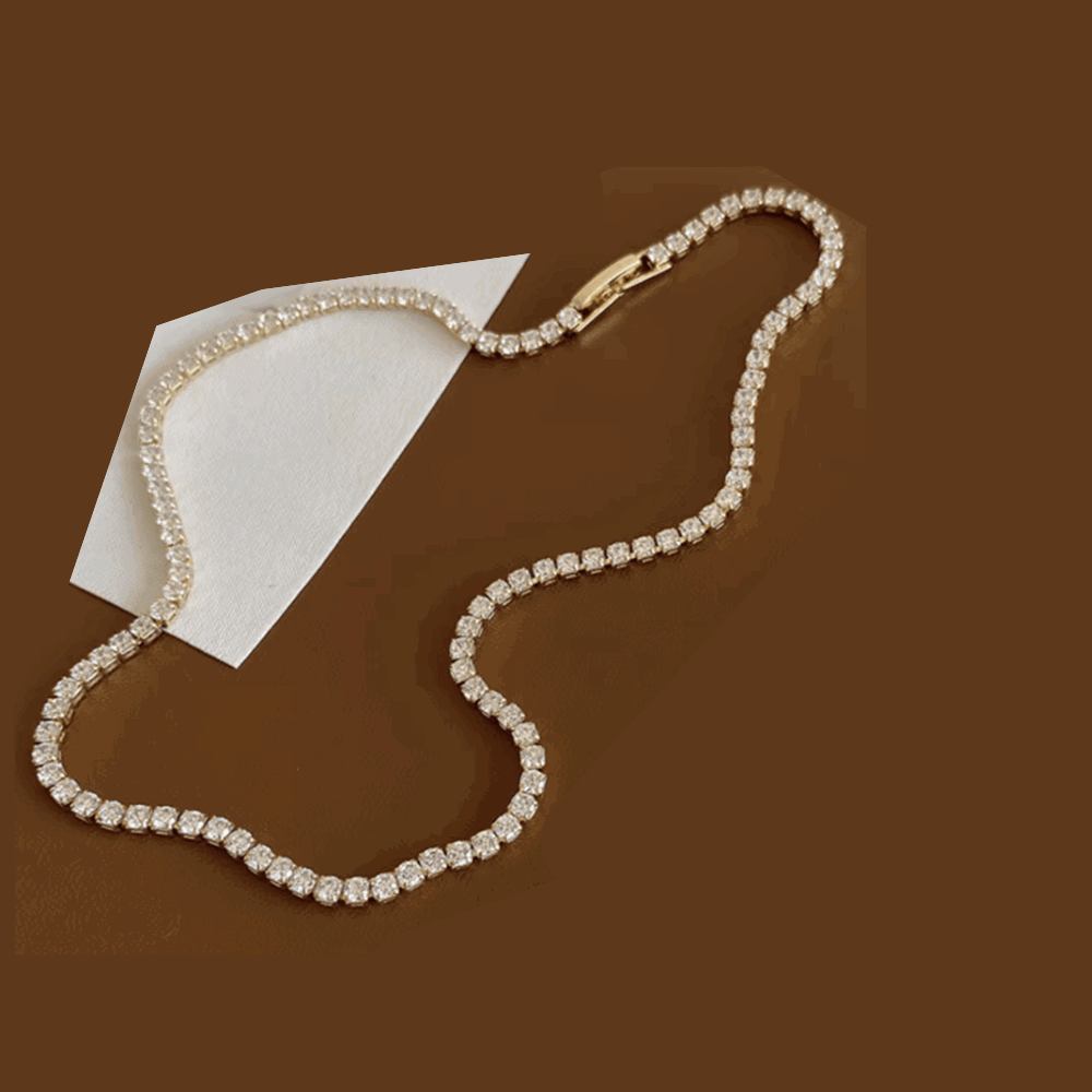 Cubic zirconia tennis necklace shaped into a heart, with round stone links
