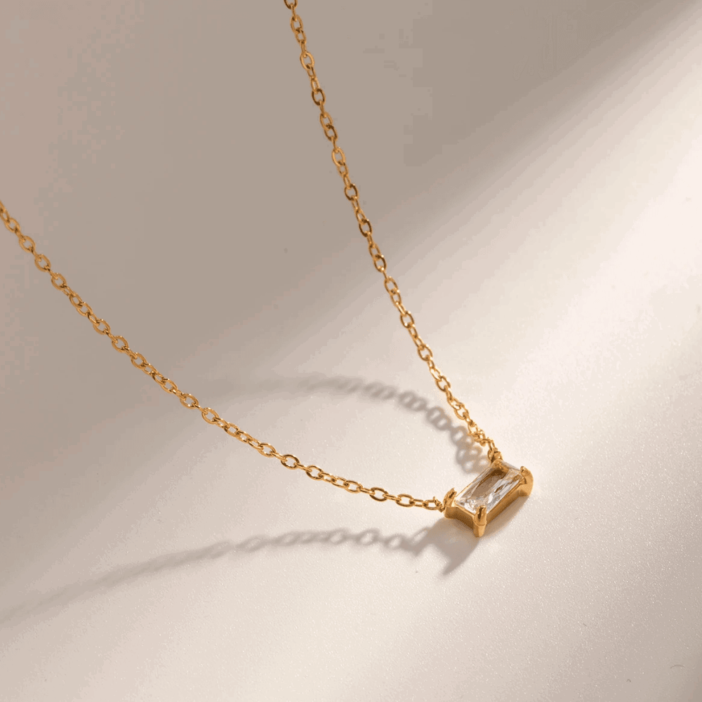 Gold-tone chain with emerald-cut cubic zirconia pendant, angled close-up